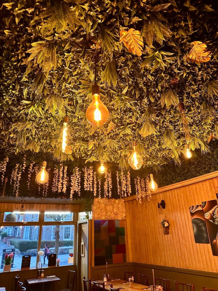 Cosy traditional Italian restaurant interior at Pacino’s in South Shields with warm lighting, rustic décor, and intimate dining tables on Ocean Road.