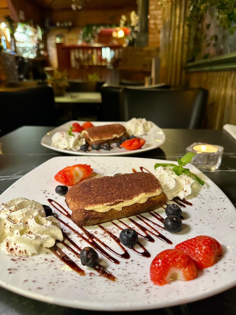 Classic Italian tiramisu dessert at Pacino’s South Shields topped with cocoa powder.