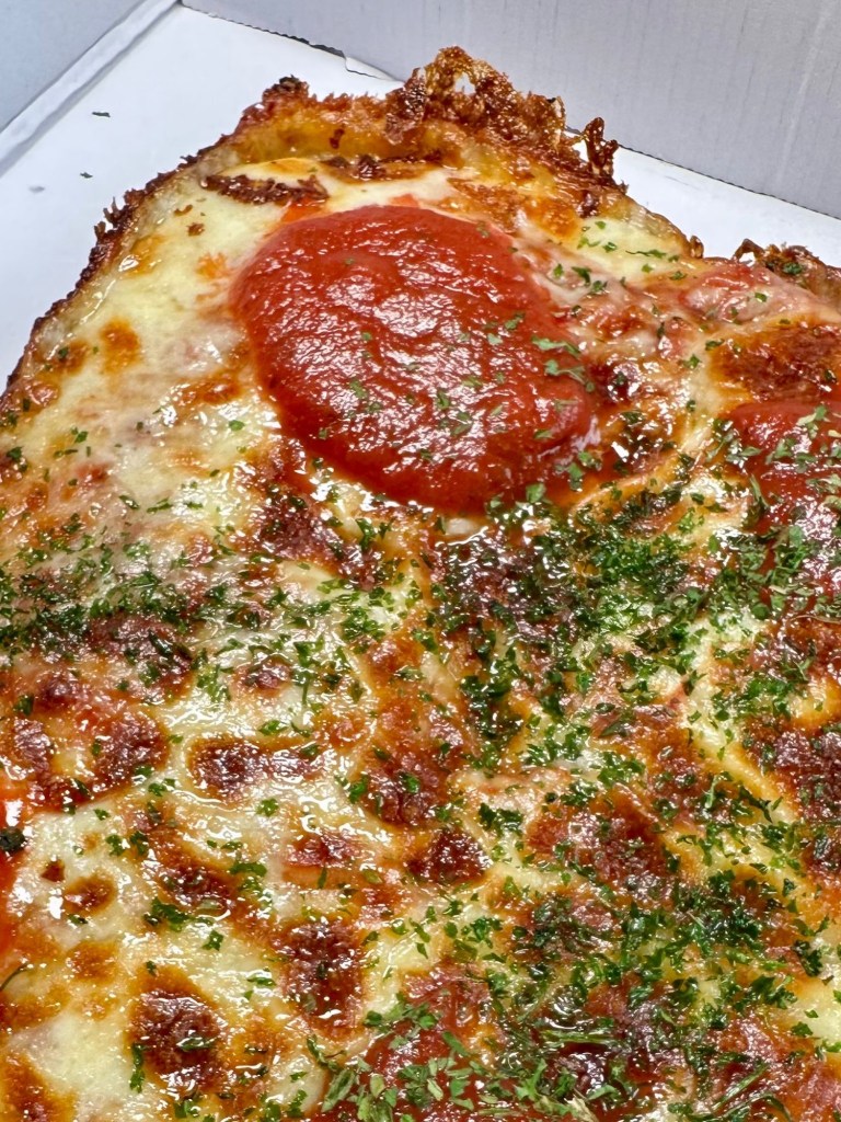 House Classic Detroit pizza slab with cheese, red sauce and fresh parsley garnish