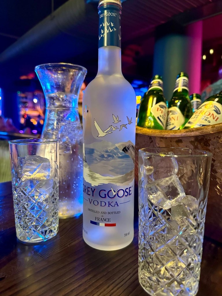 Bottle of Grey Goose vodka, assorted mixers and beer bottles displayed in an ice-filled bucket at Manahatta Newcastle.