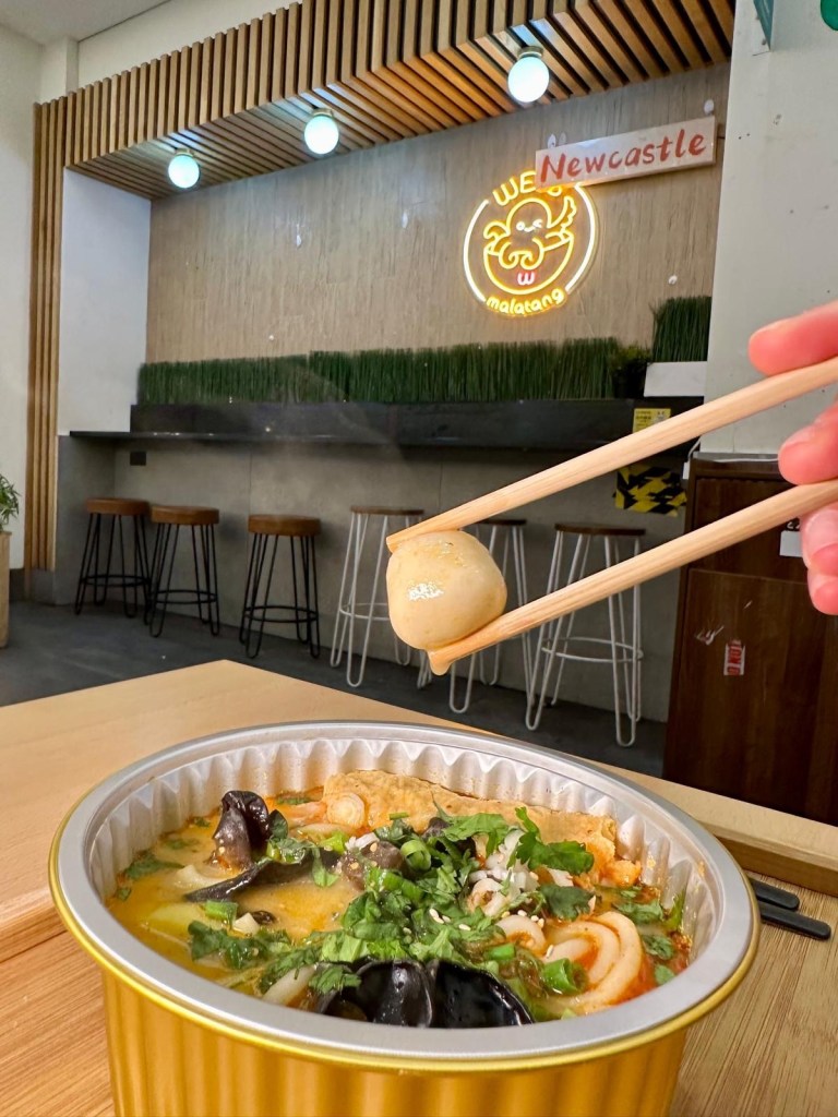 A variety of fresh seafood ingredients, including prawns, fish balls, squid, and mussels, ready to be added to a Malatang hot pot.