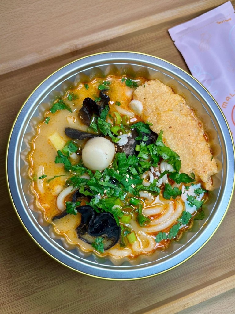 A variety of fresh seafood ingredients, including prawns, fish balls, squid, and mussels, ready to be added to a Malatang hot pot.