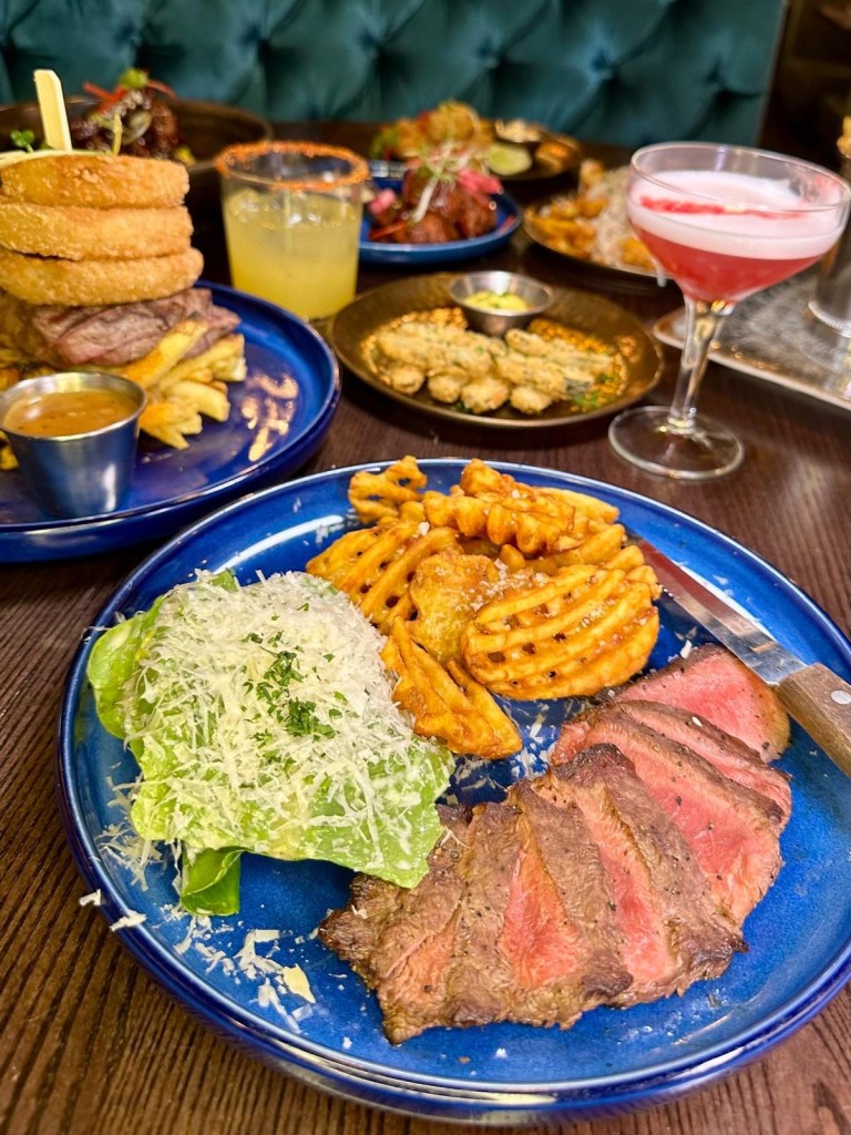 Flat Iron Steak at Manahatta Newcastle served with waffle fries and mini Caesar salad.