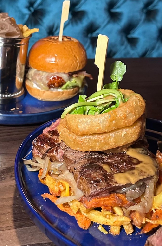 Steak Frites at Manahatta Newcastle with 7oz rump steak, garlic mushrooms, onion rings, peppercorn sauce and fries.