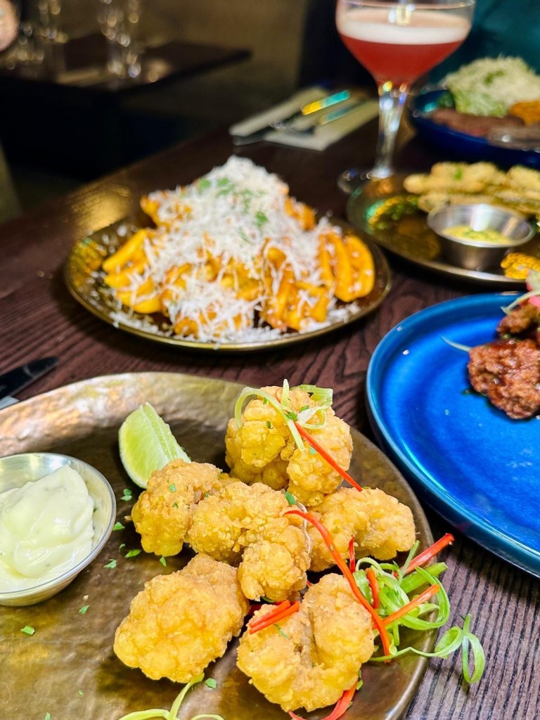 Selection of small plates at Manahatta Newcastle including frickles, salt and pepper squid, sticky chicken bites and truffle Parmesan waffle fries.