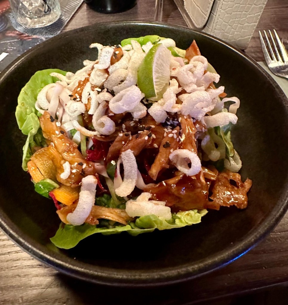 Stacked salad at Manahatta Newcastle with fresh layered greens, vegetables and house dressing.
