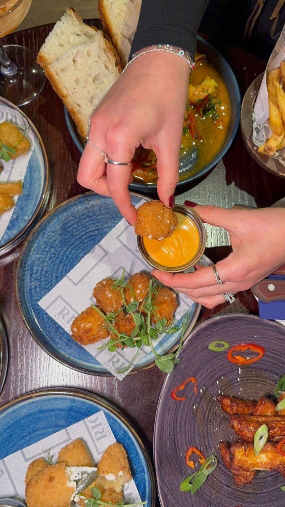 Golden mac and cheese bites served with creamy sriracha mayo dip at Bullseye Social Darts in Jesmond.
