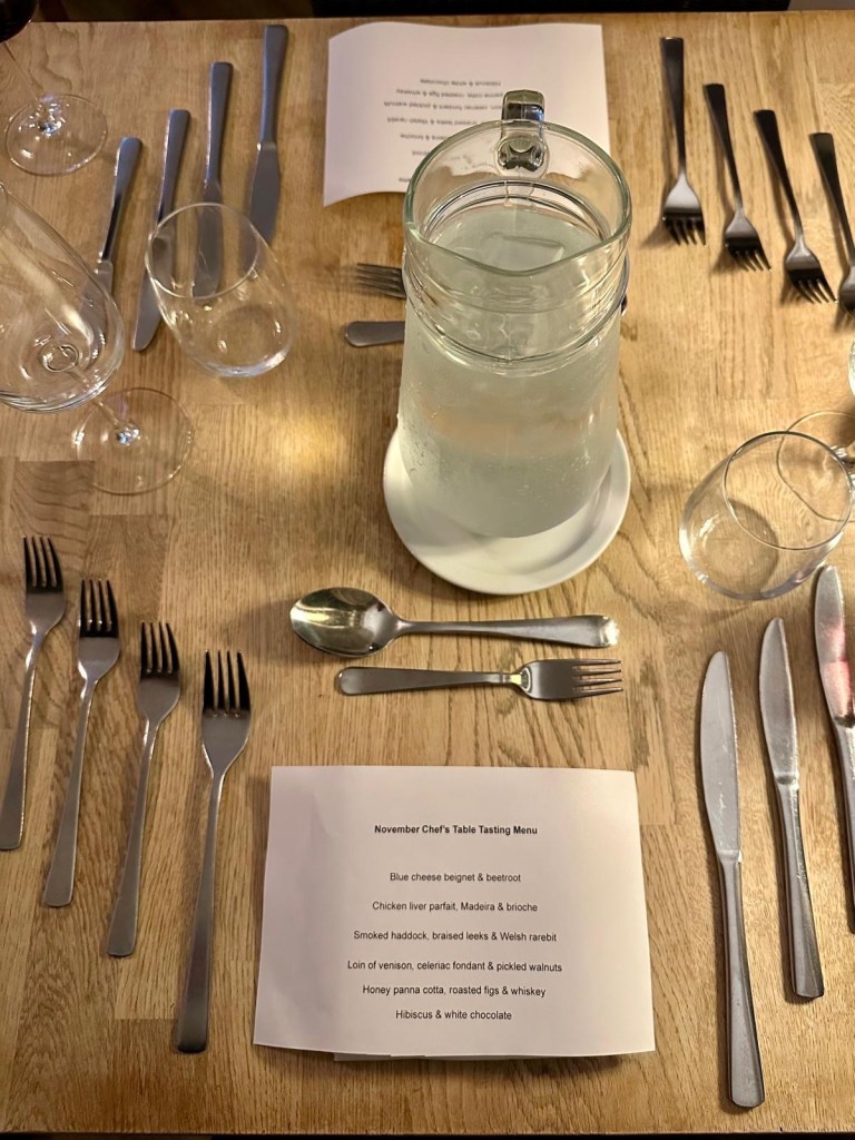 Elegantly set dining table at Eslington Villa with fine glassware, candles and tasting menu place settings.