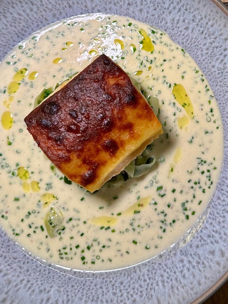 Smoked haddock with braised leeks topped with Welsh rarebit sauce