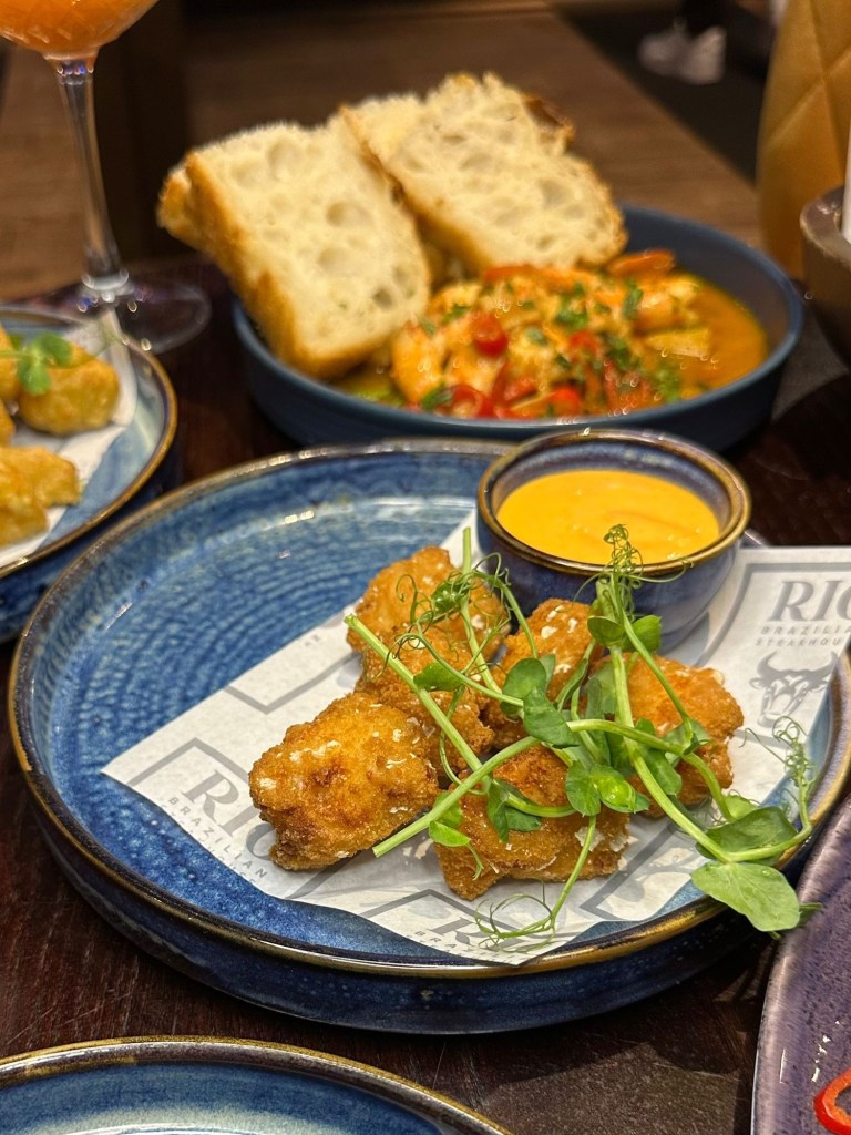 Golden mac and cheese bites served with creamy sriracha mayo dip at Bullseye Social Darts in Jesmond.