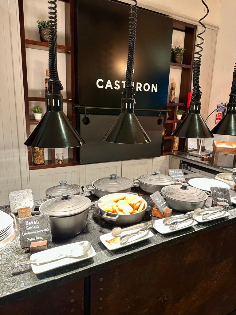 Breakfast dining area at Delta Hotels by Marriott Newcastle Gateshead with modern seating and buffet setup.
