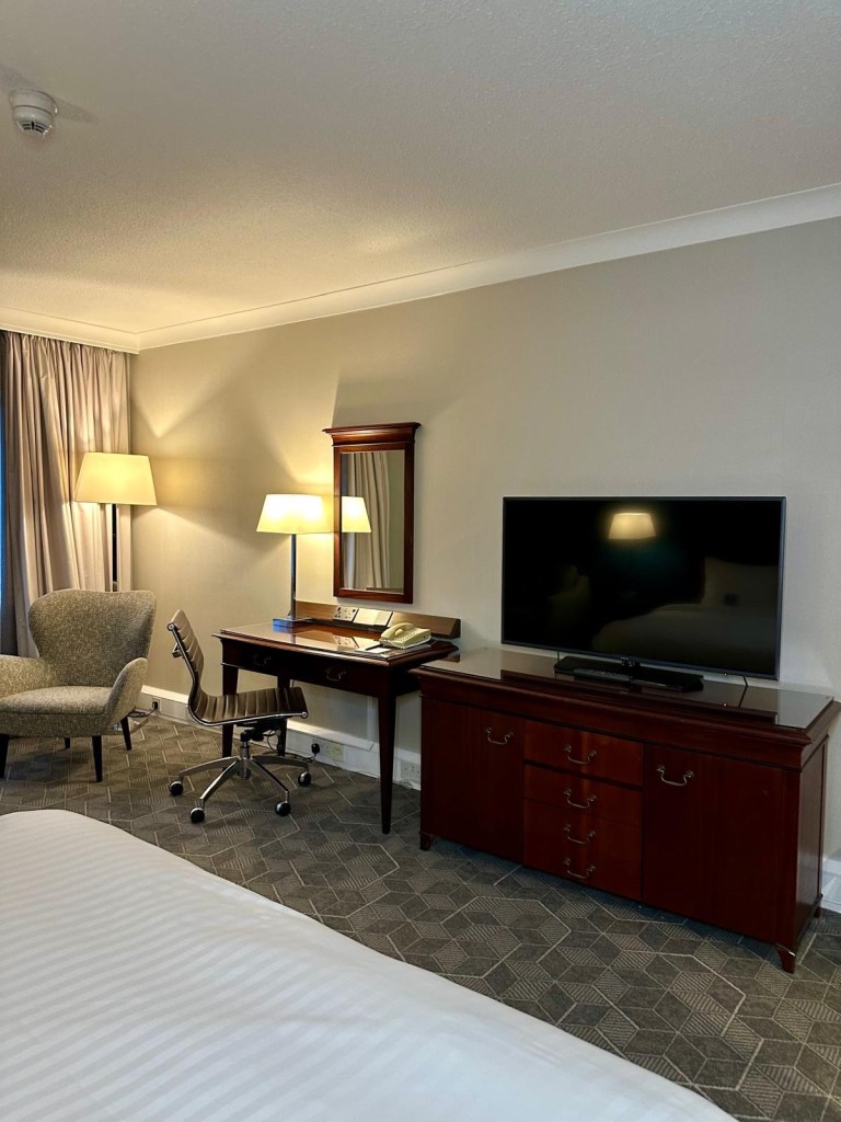 Modern hotel room at Delta Hotels by Marriott Newcastle Gateshead with double bed, workspace and contemporary decor.
