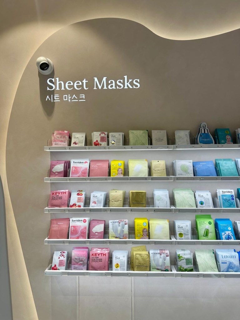 Korean sheet masks displayed on shelving at Pure Seoul Newcastle, showing a wide variety of K-beauty mask options.