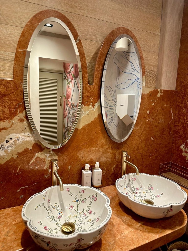 Elegant bathroom at Victors Newcastle with floral-patterned sinks