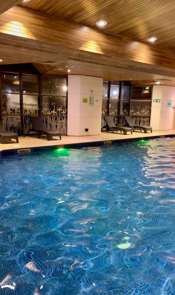 Indoor swimming pool at Delta Hotels by Marriott Newcastle Gateshead with lounge seating and modern design.