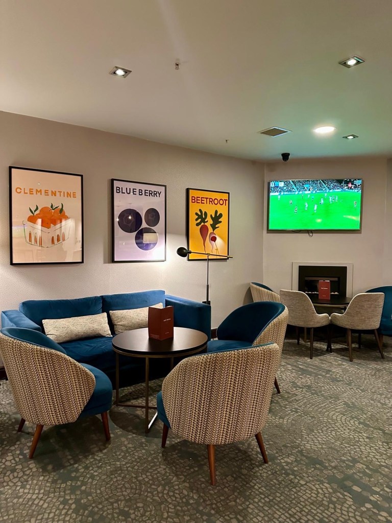 Bar area at Cast Iron Bar & Restaurant in Delta Hotels by Marriott Newcastle Gateshead with TV showing football.