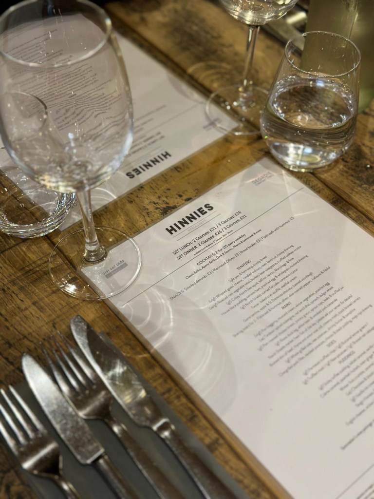 Close up of dining table with Hinnies restaurant menu in Whitley Bay