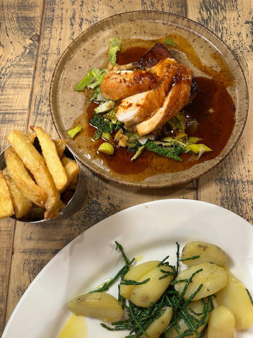 Pan roasted chicken breast with potato gratin and parmesan truffle fries at Hinnies Whitley Bay