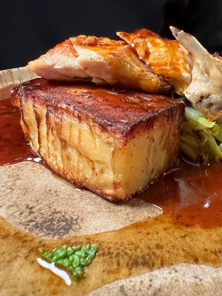 Pan roasted chicken breast with potato gratin, sprout tops, leeks and truffled jus at Hinnies restaurant