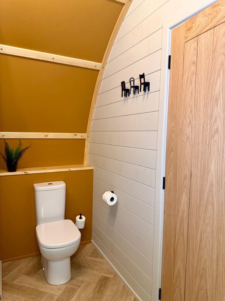 Luxury cabin bathroom with rainfall shower at Hewn Yorkshire