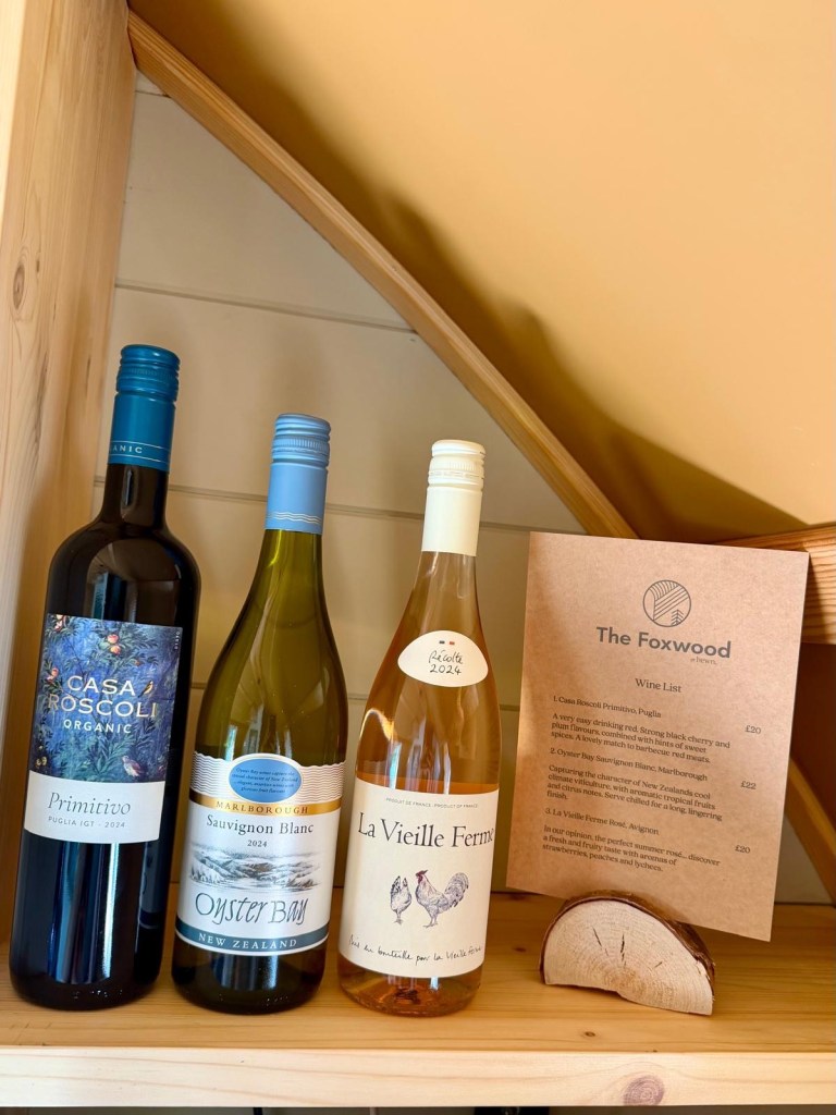 Selection of wine bottles available to purchase inside a Hewn Yorkshire cabin