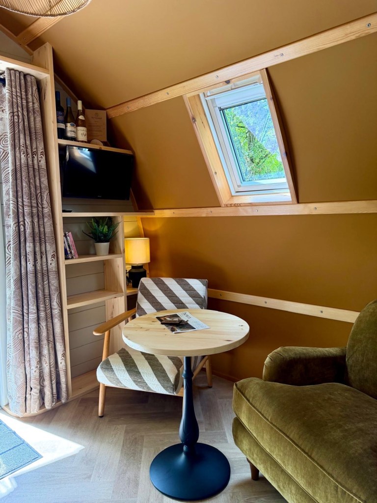 Cosy armchairs and coffee table inside Hewn Yorkshire Scandi cabin