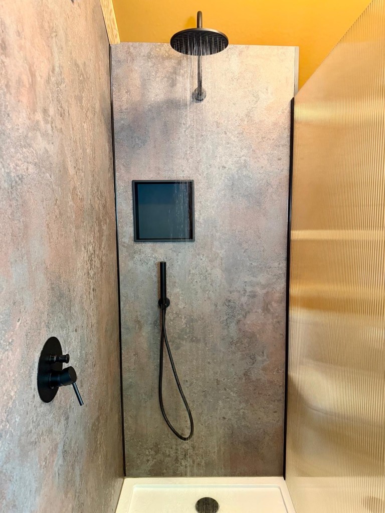 Luxury cabin bathroom with rainfall shower at Hewn Yorkshire