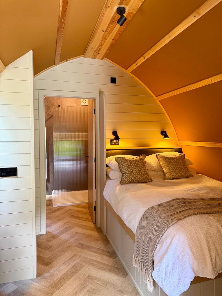 Comfortable bed inside the refurbished cabin at Hewn Yorkshire