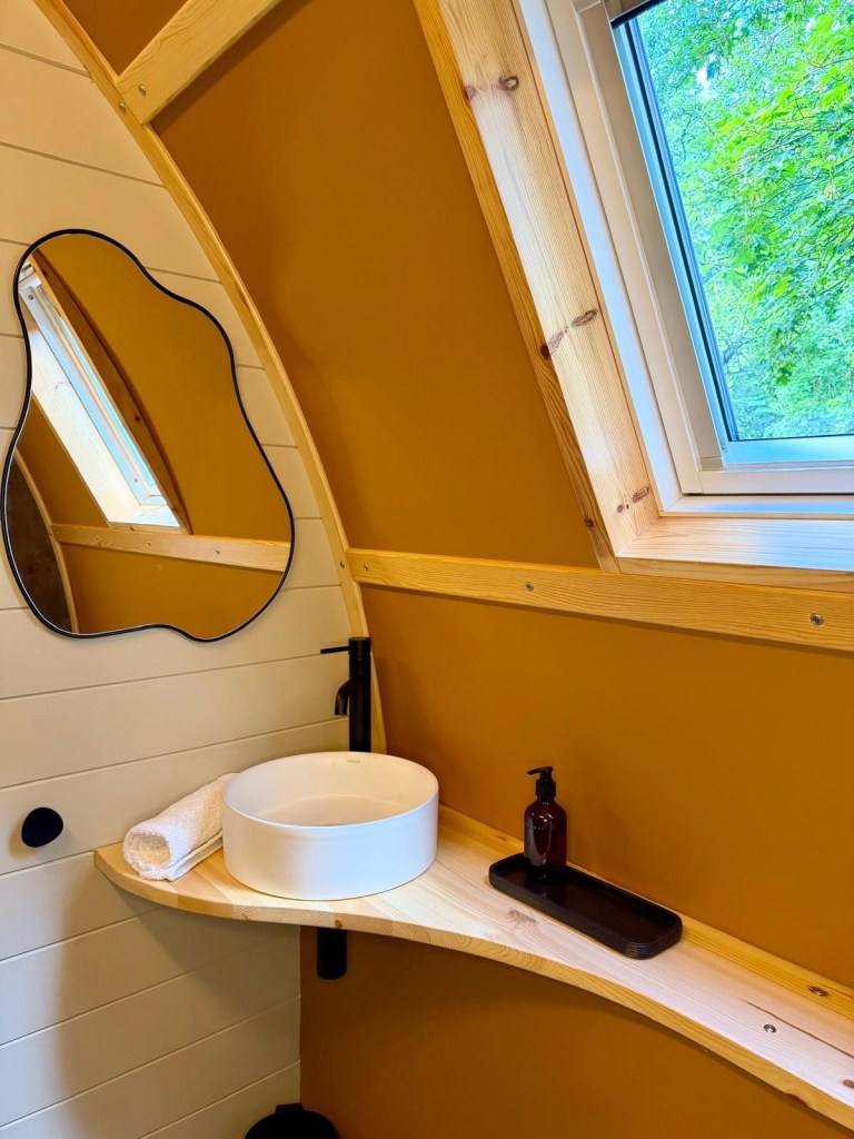 Luxury cabin bathroom with rainfall shower at Hewn Yorkshire