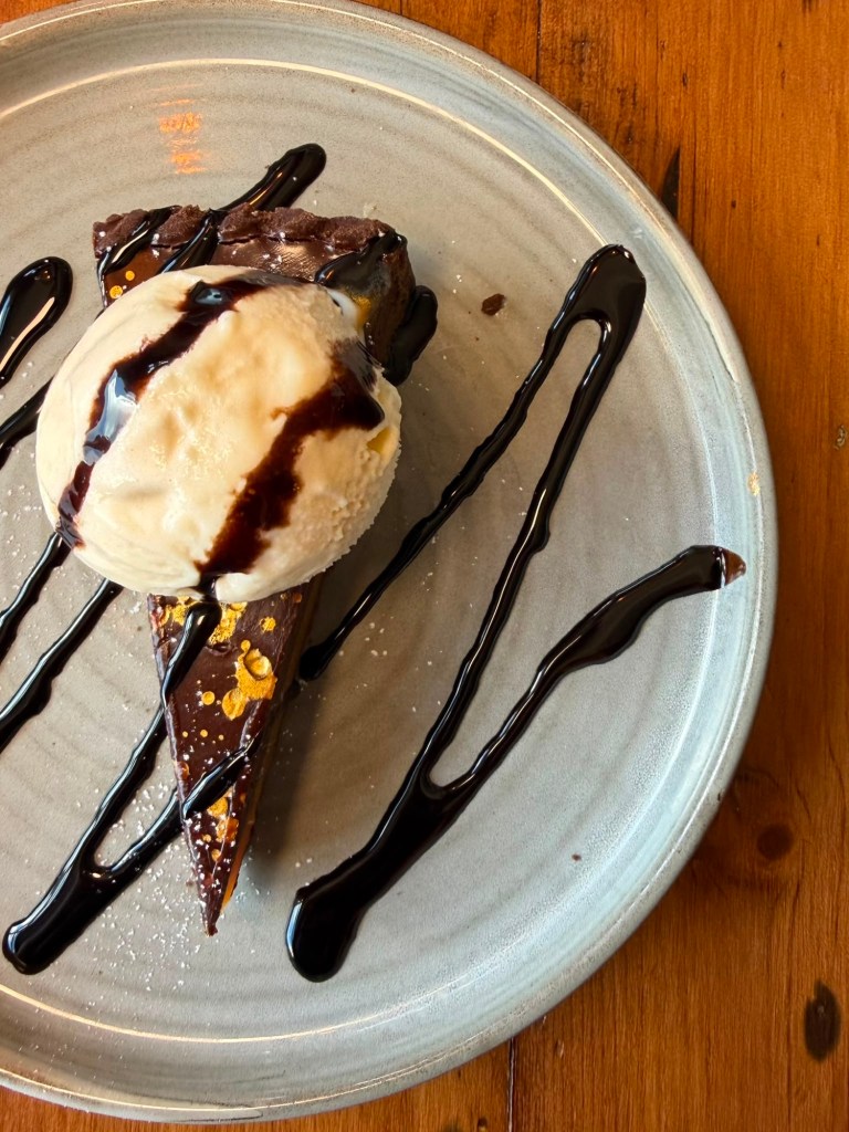 Chocolate tart with ice cream and chocolate drizzle at The Queen's Head Cullercoats