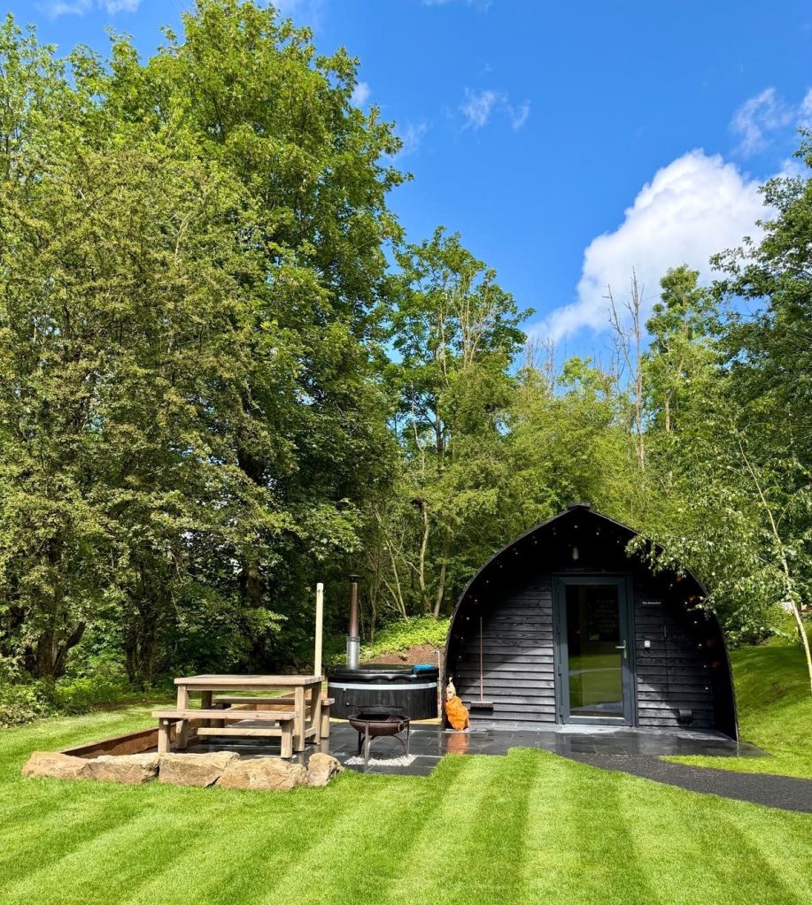 Private Finnish wood fired hot tub outside a cabin at Hewn Yorkshire